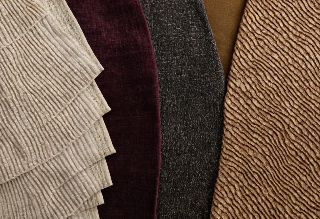 Fan of upholstery fabric samples in silk, linen, wool, cotton, viscose and blends showing different lusters and weaves